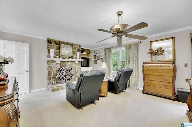 living room with ceiling fan, a stone fireplace, light carpet, and crown molding