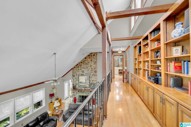 corridor featuring high vaulted ceiling, light hardwood / wood-style flooring, and beamed ceiling