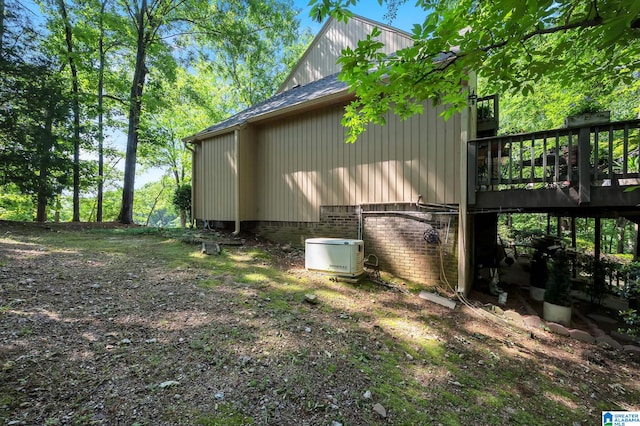 view of property exterior featuring a wooden deck