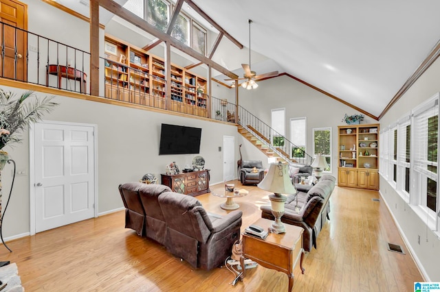 living room with ceiling fan, light hardwood / wood-style flooring, and high vaulted ceiling