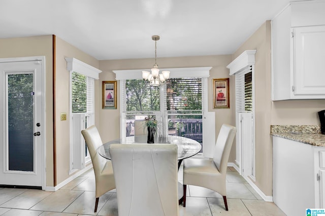 dining area featuring a notable chandelier and light tile floors