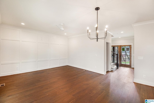 unfurnished dining area featuring ceiling fan with notable chandelier, ornamental molding, dark hardwood / wood-style floors, and french doors