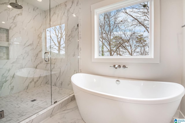 bathroom with plenty of natural light and shower with separate bathtub