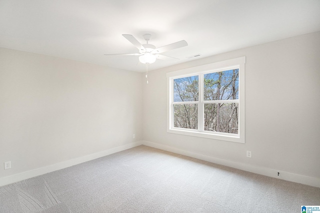 carpeted spare room featuring ceiling fan