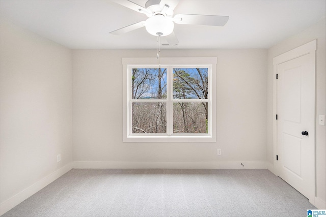 unfurnished room featuring ceiling fan and carpet floors