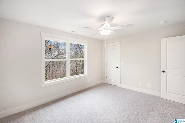 empty room featuring carpet floors and ceiling fan