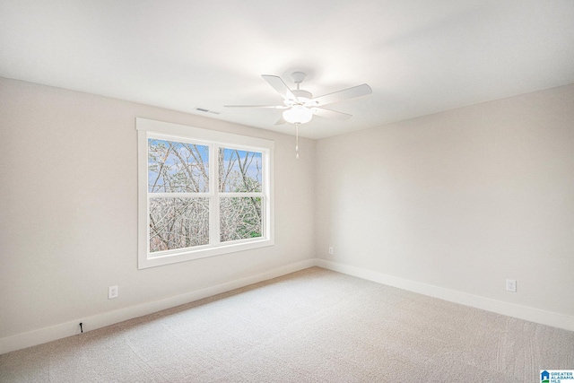 empty room with ceiling fan and carpet flooring