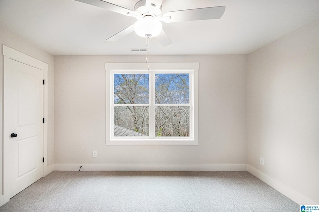 spare room with ceiling fan and carpet flooring