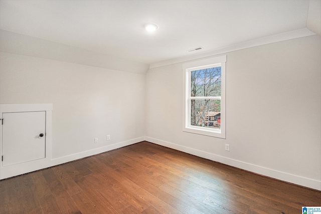 unfurnished room with dark wood-type flooring