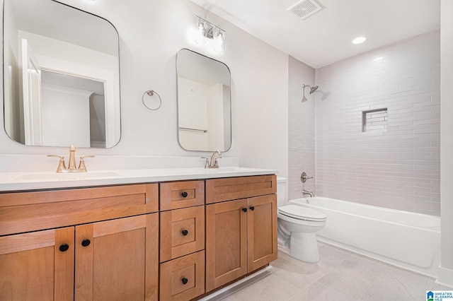 full bathroom featuring vanity, tiled shower / bath combo, and toilet