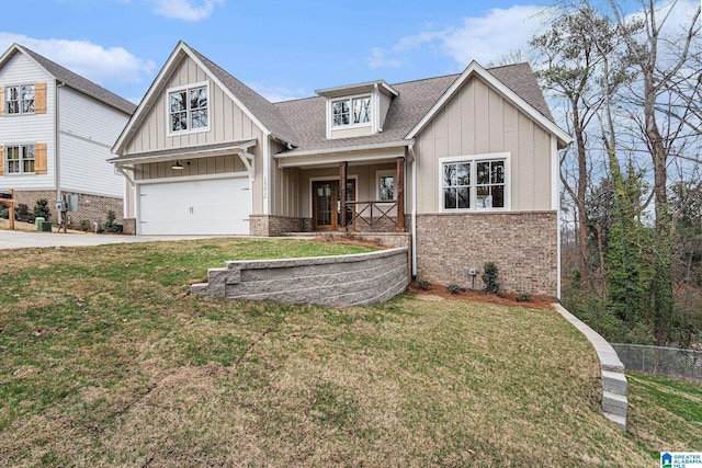 view of front of house featuring a porch, a garage, and a front yard