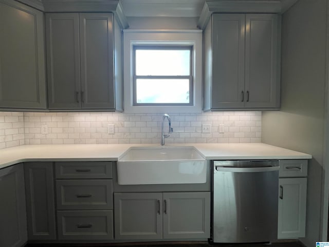 kitchen with backsplash, stainless steel dishwasher, gray cabinets, and sink