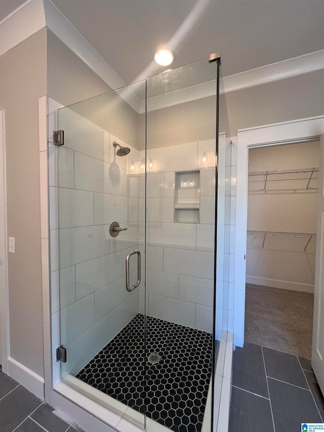 bathroom featuring an enclosed shower and tile floors