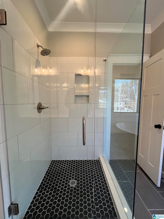 bathroom with tile walls, a shower with shower door, and tile flooring