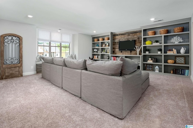 living room with light carpet and built in features