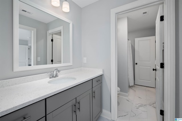 bathroom with vanity, toilet, and tile patterned flooring