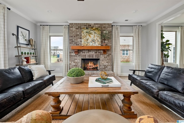 living room with crown molding, light wood-type flooring, a fireplace, and a wealth of natural light