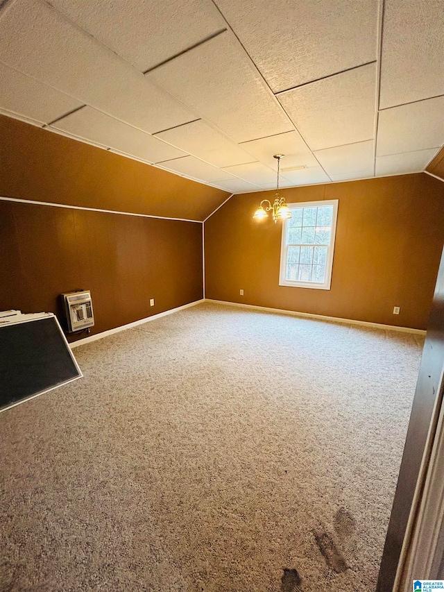 empty room featuring an inviting chandelier and carpet floors