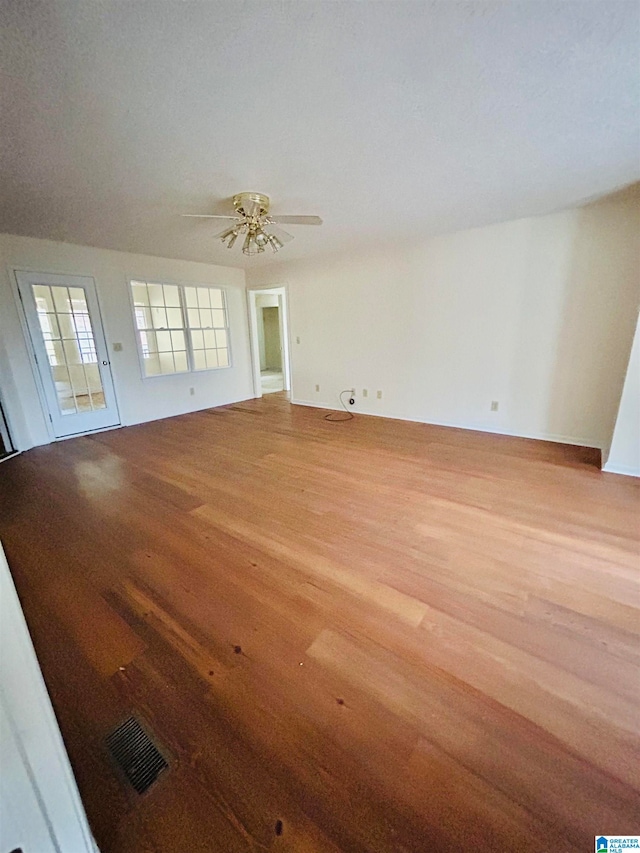 spare room featuring ceiling fan and light hardwood / wood-style flooring