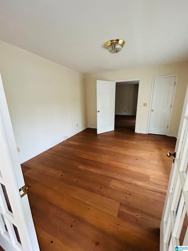 spare room featuring dark hardwood / wood-style floors