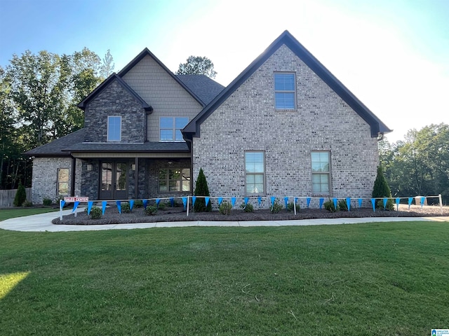 rear view of property with a yard