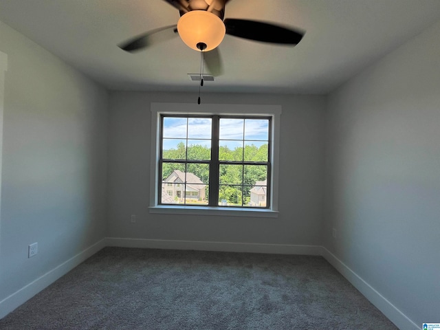 empty room with ceiling fan and carpet