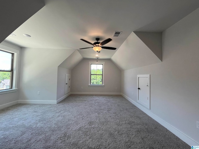 additional living space featuring carpet flooring, ceiling fan, and lofted ceiling