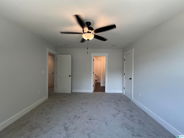 unfurnished bedroom featuring carpet, ensuite bath, and ceiling fan