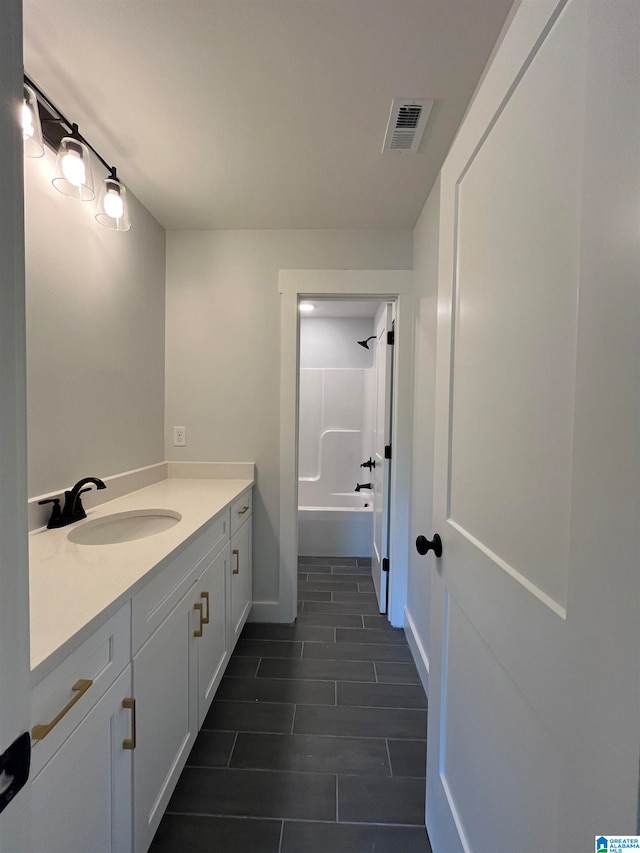 bathroom featuring vanity and  shower combination