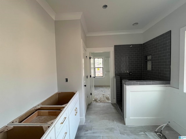 bathroom featuring tiled shower and ornamental molding