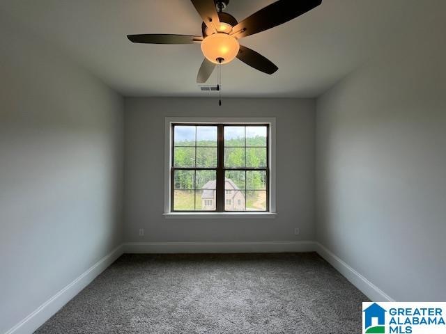 empty room with carpet floors and ceiling fan