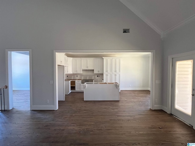 unfurnished living room with crown molding, high vaulted ceiling, and dark wood-type flooring