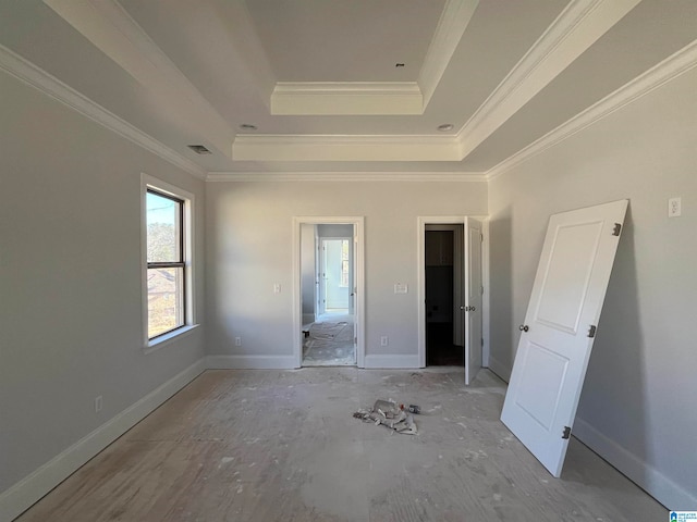 unfurnished bedroom with a raised ceiling and ornamental molding