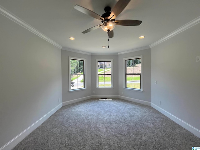 empty room with carpet flooring, ceiling fan, and ornamental molding