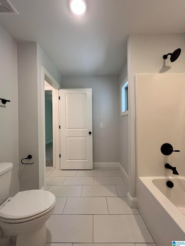 bathroom featuring tile patterned floors, bathtub / shower combination, and toilet