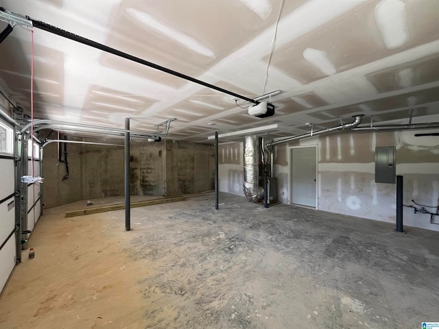 garage with electric panel, a garage door opener, and heating unit