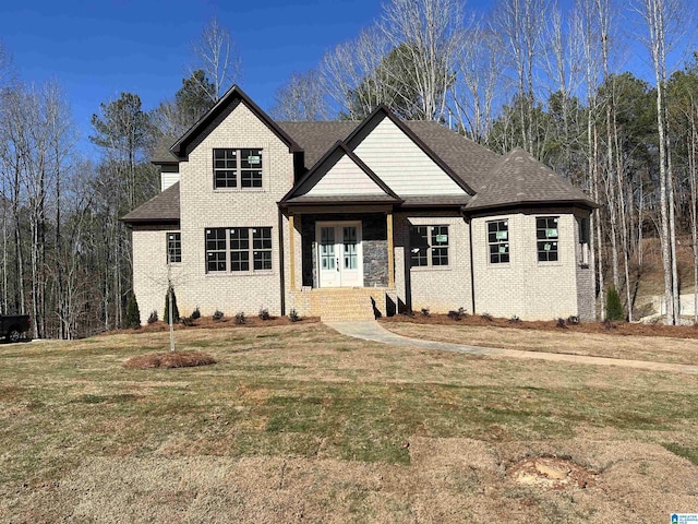 view of front of property with a front yard and french doors