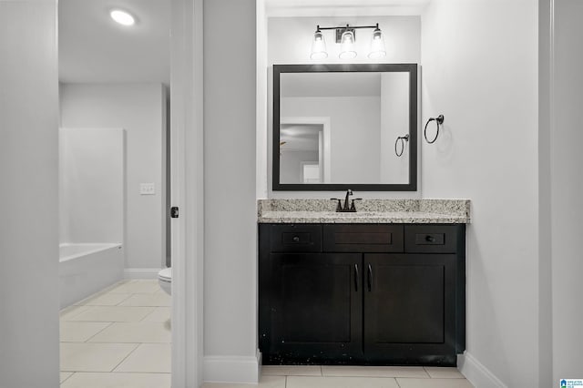 full bath featuring toilet, tile patterned floors, vanity, and baseboards