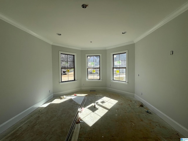 spare room with a healthy amount of sunlight and ornamental molding