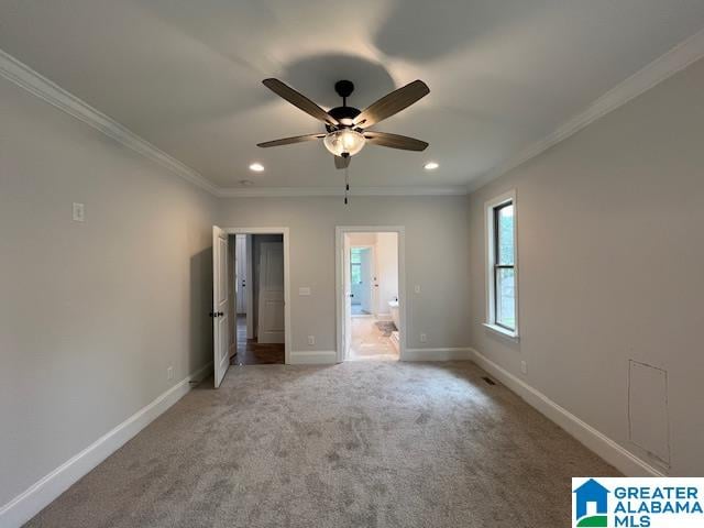 unfurnished bedroom featuring ceiling fan, crown molding, carpet floors, and ensuite bathroom