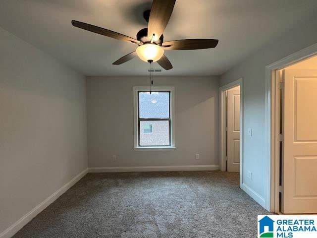 unfurnished bedroom featuring ceiling fan and carpet