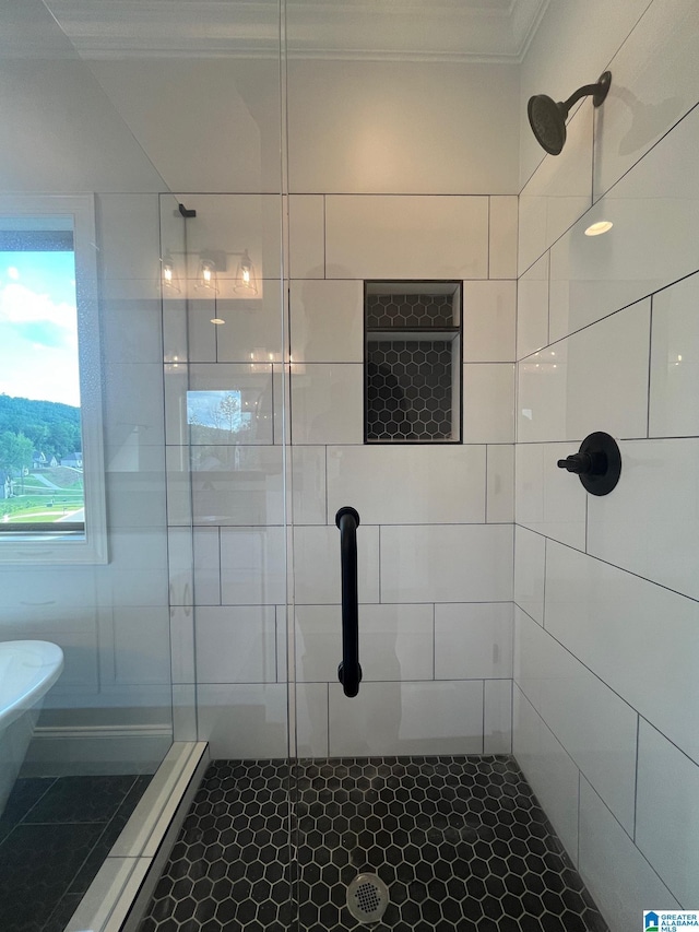 bathroom with tile patterned floors, crown molding, and a shower with shower door