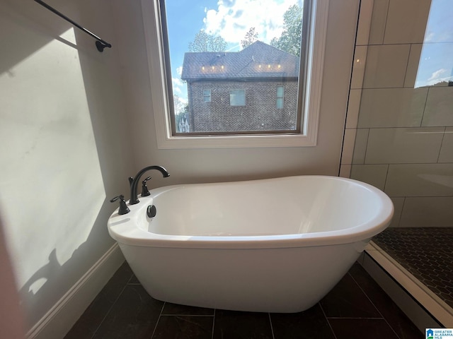 bathroom with tile patterned flooring and a bathing tub