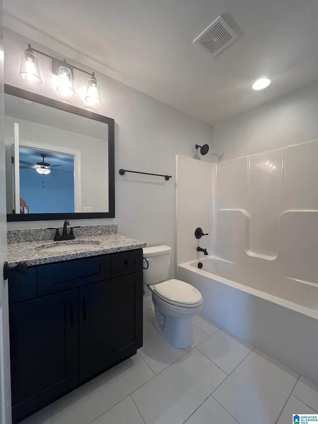 full bathroom with vanity, washtub / shower combination, tile patterned flooring, ceiling fan, and toilet