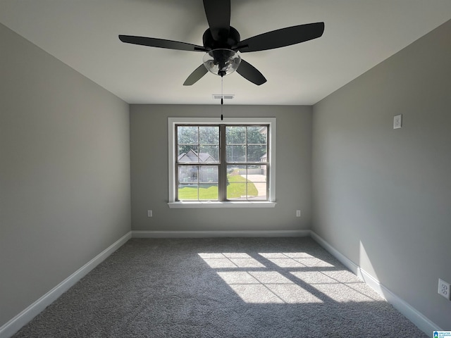 spare room with ceiling fan and light carpet