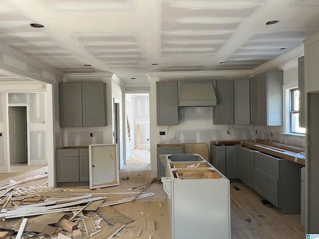 kitchen with ornamental molding, gray cabinetry, and custom exhaust hood