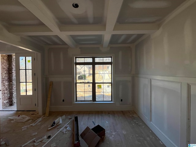 interior space with beam ceiling, hardwood / wood-style floors, and coffered ceiling