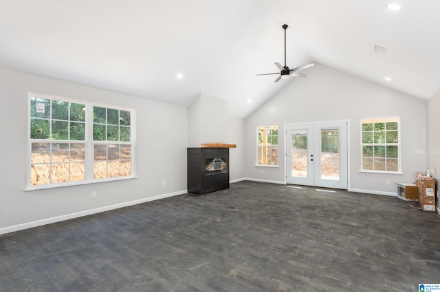 unfurnished living room with french doors, a multi sided fireplace, ceiling fan, and high vaulted ceiling