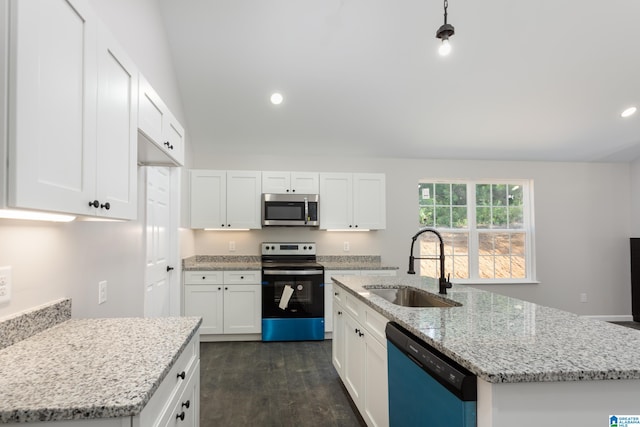 kitchen featuring dark wood-type flooring, light stone counters, an island with sink, appliances with stainless steel finishes, and sink