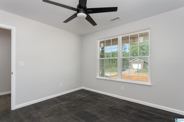 empty room with dark hardwood / wood-style flooring and ceiling fan